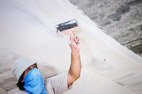 Manual worker with wall plastering tools Stock Photos