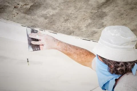 Manual worker with wall plastering tools Stock Photos