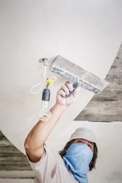 Manual worker with wall plastering tools Stock Photos