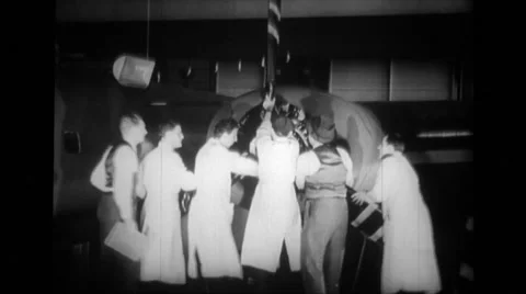 Manual workers attaching propeller to aeroplane engine Stock Footage