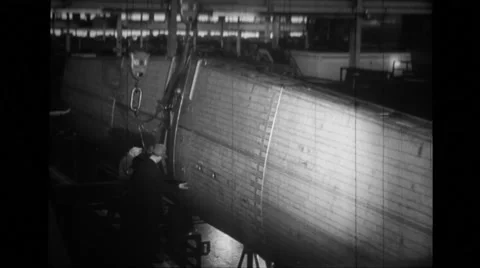 Manual workers working and derrick lifting wing section of B-24 Liberator Stock Footage
