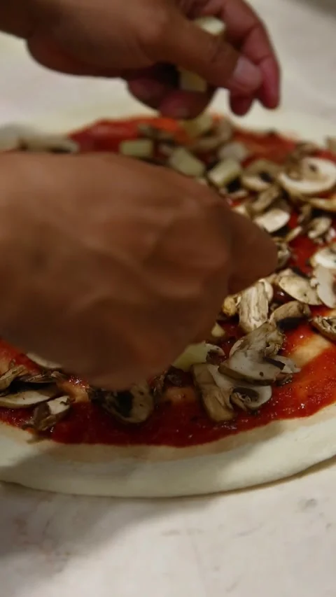 Manually add cheese to pizza; perfect for food videos, restaurant videos Stock Footage 311030199