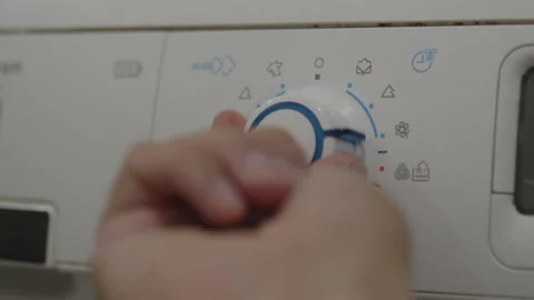 Manually changing laundry washing programme 4K footage Vidéo 172252374