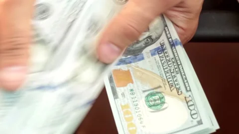 Manually count a bundle of one hundred dollar bills Stock Footage 146775607
