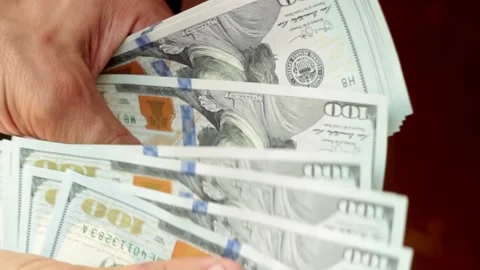 Manually count one hundred dollar bills with blue security tape Stock Footage 146775611