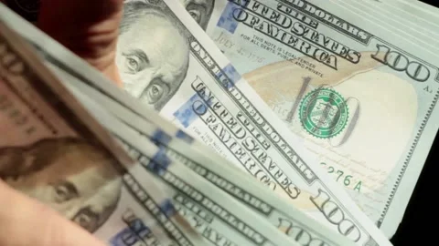 Manually counting hundred dollar bills on dark background Stock Footage 146775597