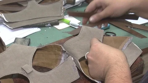 Manually cutting of skin during craft manufacturing leather goods. Workshop of s Stock Footage 90371634