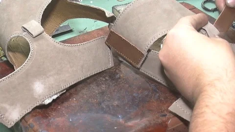 Manually cutting of skin during craft manufacturing leather goods. Workshop of s Stock Footage 90371678