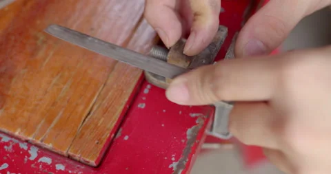Manually filing a corroded bolt thread, showing metal repair work and surface. Stock Footage 311665298