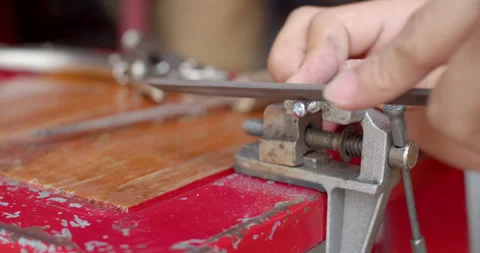 Manually filing a corroded bolt thread, showing metal repair work and surface. Stock Footage 311665343