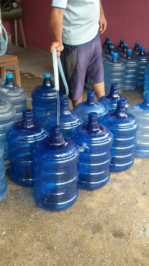 Manually filling gallons of water Stock Footage 282708134