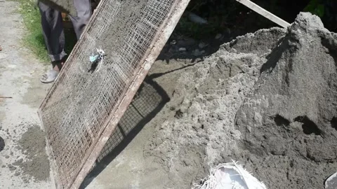 Manually filtering sand Stock Footage 268385040