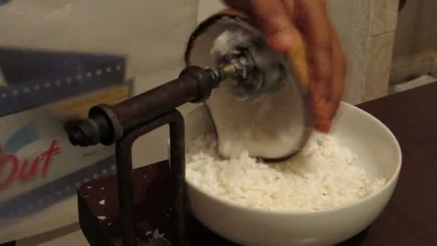 Manually grating a coconut. Concept video showing coconut grating. Stock Footage 133543354