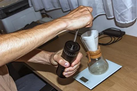 Manually Grinding Coffee Beans with Hand Coffee Grinder Stock Photos