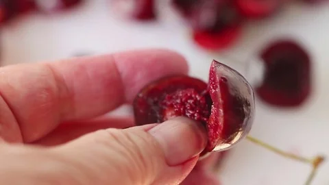 Manually pitting cherries Stock Footage 81746719