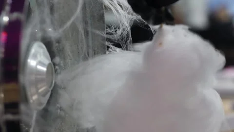 Manually rolling out cotton candy in a cotton candy machine. Making candy floss Stock Footage 277654456