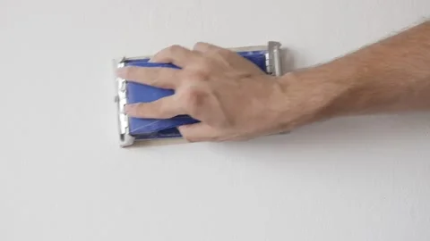 Manually sanding wall before priming and painting slow-mo video Stock Footage 94263915