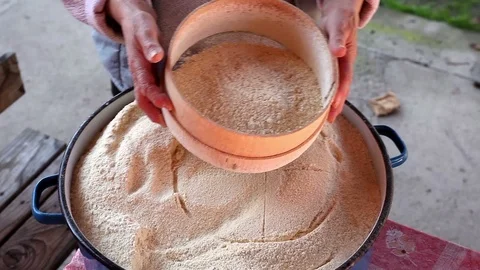 Manually Sifting corn flour Stock Footage 127078749