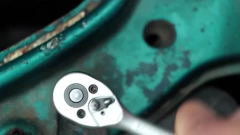 Manually tighten the bolt with a wrench and remove the wrench Stock Footage 150613657