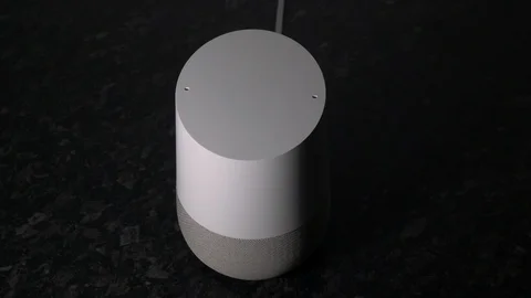 Manually Turning the Volume Up By Hand On A Smart Home Voice Assistant Speaker Stock Footage 104119038