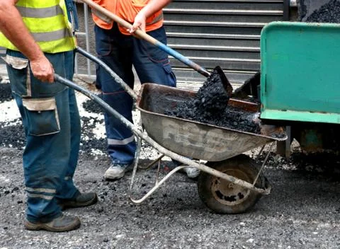 Manually unloading asphalt Stock Photos