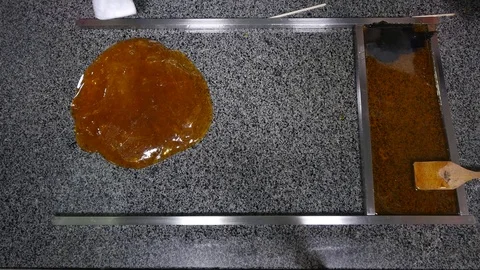 Manufacture of caramel candies, stirring caramel. top view Stock Footage
