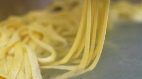 Manufacture process of spaetzle egg noodles in water, german recipe of Stock Footage 255720949