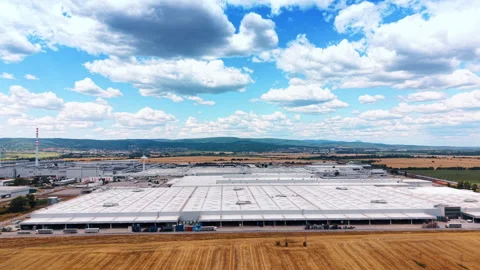 Manufacturing complex beneath large cumulus clouds Stock Footage 340558853