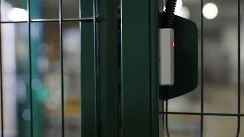 Manufacturing engineer is opening electromagnetic lock of door in a secret Stock Footage 100021419