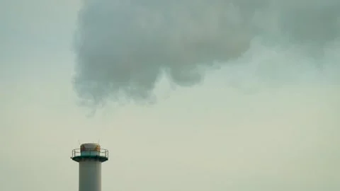 Manufacturing facility smokestack producing large smoke cloud. Industrial air Video stock 333314691