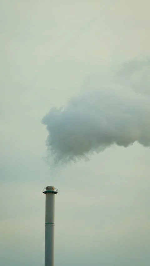 Manufacturing facility stack with heavy smoke billowing upward. Environmental Stock Footage 331160931