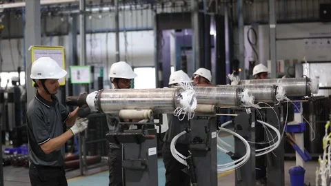 A manufacturing line where a team of workers in are meticulously assembling 스톡 동영상 328333831