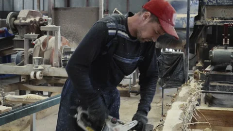 Manufacturing Male Worker Using Logging Chainsaw In A Wood Production Process Stock Footage 164316194