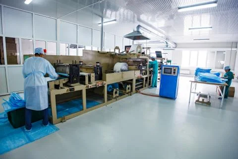 Manufacturing medical supplies. Disposable gown production line Stock Photos