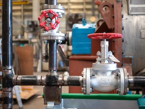Manufacturing of pipes with valves Stock Photos