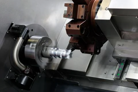 Manufacturing process on CNC lathe machine closeup Stock Photos