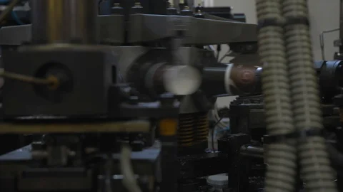 Manufacturing process of paper cup for coffee or tea. Rotating machine parts. Stock Footage 92670441