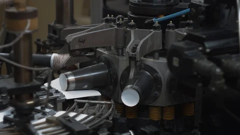 Manufacturing process of paper cup for coffee or tea. Rotating machine parts. Stock Footage 92674585