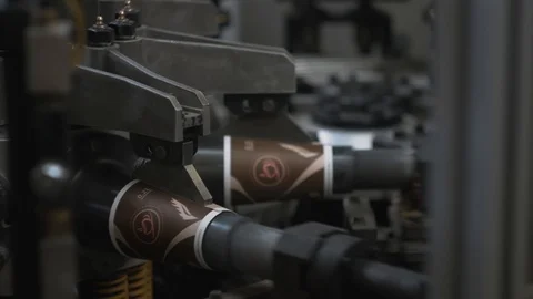 Manufacturing process of paper cup for coffee or tea. Rotating machine parts. Stock Footage 92675343