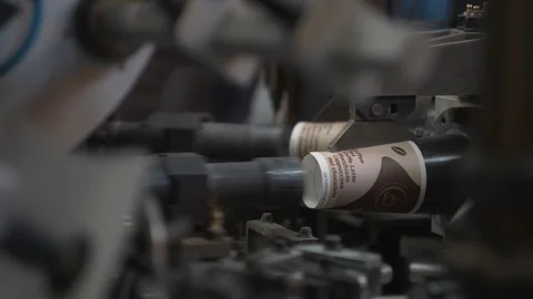 Manufacturing process of paper cup for coffee or tea. Rotating machine parts. Stock Footage 92675905