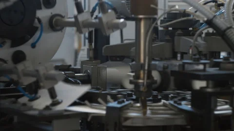 Manufacturing process of paper cup for coffee or tea. Rotating machine parts. Stock Footage 92695896