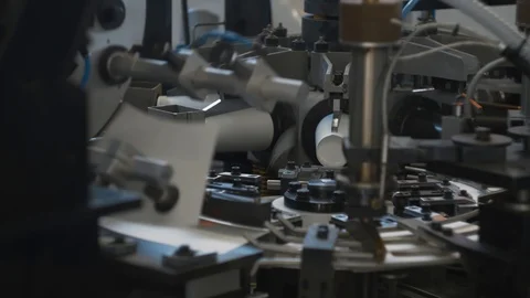 Manufacturing process of paper cup for coffee to go. Rotating machine parts. Stock Footage 92732320