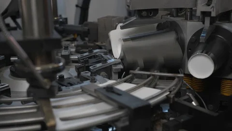 Manufacturing process of paper cup for coffee or tea. Rotating machine parts. Stock Footage 92798084