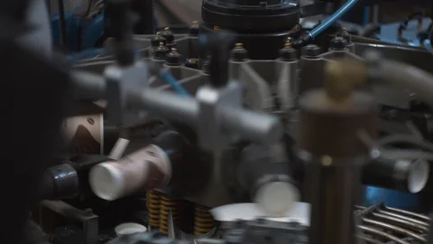 Manufacturing process of paper cups for hot drinks. Rotating machine parts. Stock Footage 92679001
