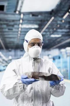 Manufacturing professional examining semiconductor substrate Stock Photos