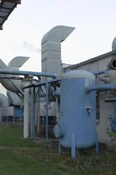 Manufacturing site featuring network of connected blue utility installations Stock Photos