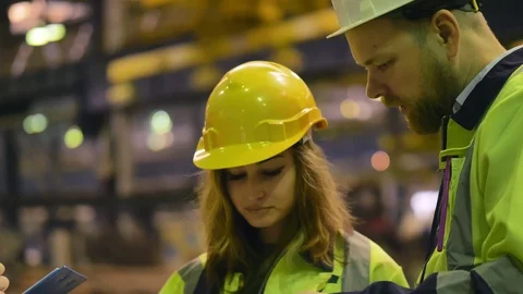 Manufacturing technicians looking through documents Stock Footage 106570096