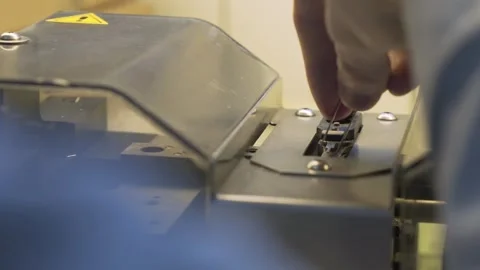 Manufacturing transistors on a semi-automatic machine at the factory. Stock Footage 332539281
