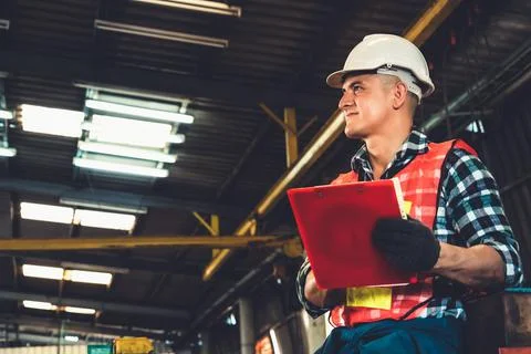 Manufacturing worker working with clipboard to do job procedure checklist . Stock Photos