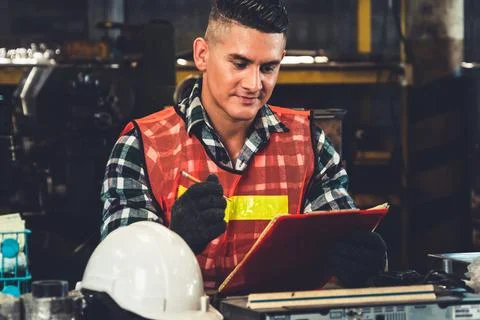 Manufacturing worker working with clipboard to do job procedure checklist . Stock Photos